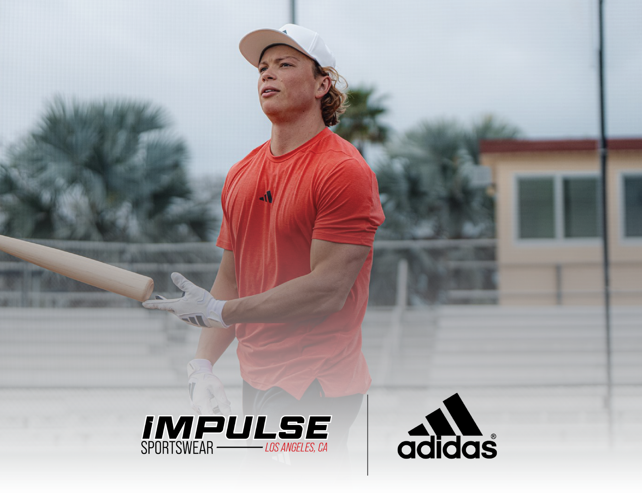 Man in adidas hat and shirt, tossing a baseball bat